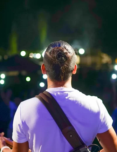 Musician Performing at Night with Audience Lights